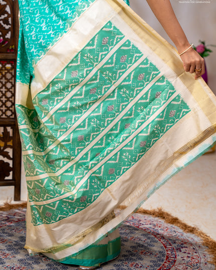 Pochampally silk saree teal green and cream with allover ikat weaves and ikat woven buttas & zari woven border