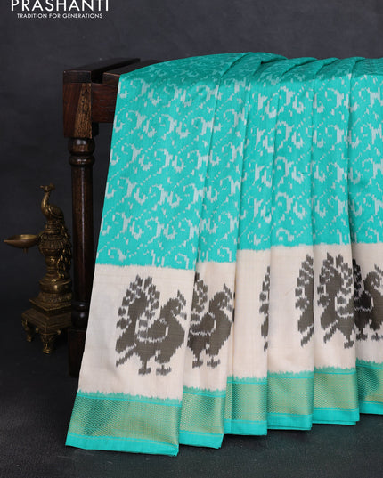 Pochampally silk saree teal green and cream with allover ikat weaves and ikat woven buttas & zari woven border