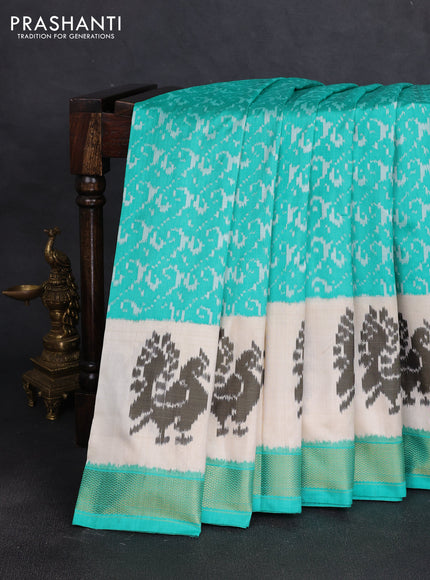 Pochampally silk saree teal green and cream with allover ikat weaves and ikat woven buttas & zari woven border