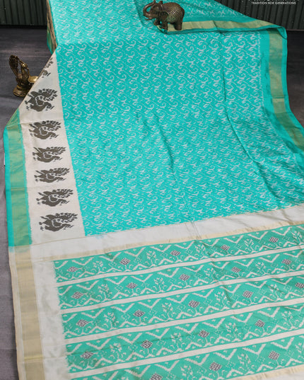 Pochampally silk saree teal green and cream with allover ikat weaves and ikat woven buttas & zari woven border