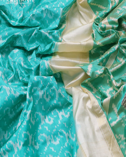Pochampally silk saree teal green and cream with allover ikat weaves and ikat woven buttas & zari woven border