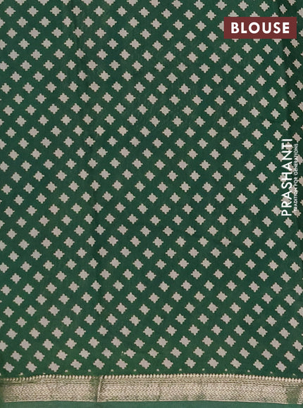 Muslin silk saree rust shade and green with allover kalamkari prints and zari woven border