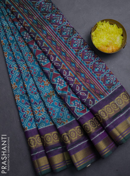 Semi tussar saree dual shade of bluish green and purple with allover ikat prints and ikat woven zari border