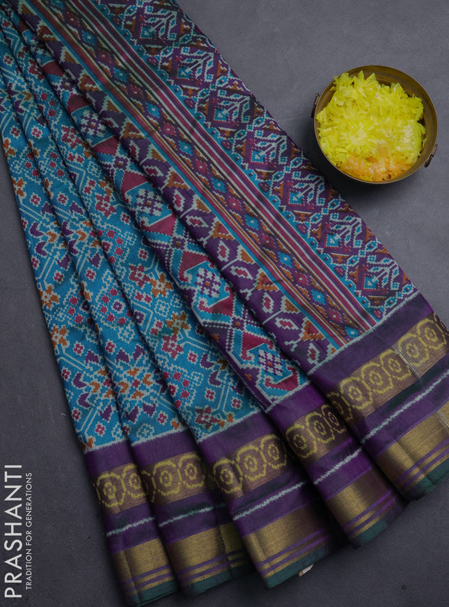 Semi tussar saree dual shade of bluish green and purple with allover ikat prints and ikat woven zari border