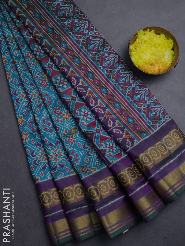 Semi tussar saree dual shade of bluish green and purple with allover ikat prints and ikat woven zari border