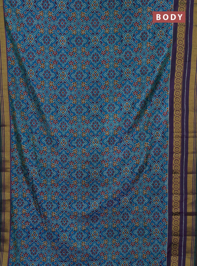 Semi tussar saree dual shade of bluish green and purple with allover ikat prints and ikat woven zari border