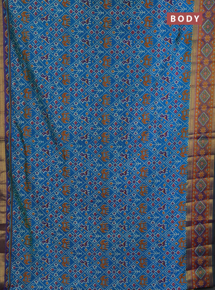 Semi tussar saree cs blue and green with allover patola prints and ikat zari woven border