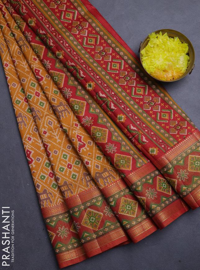 Semi tussar saree mustard yellow and rustic orange with allover patola prints and ikat zari woven border