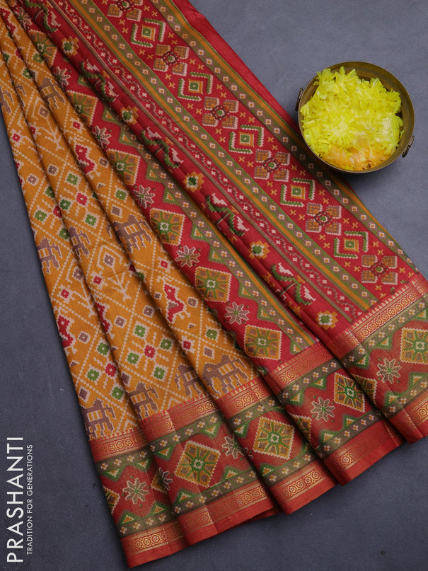 Semi tussar saree mustard yellow and rustic orange with allover patola prints and ikat zari woven border