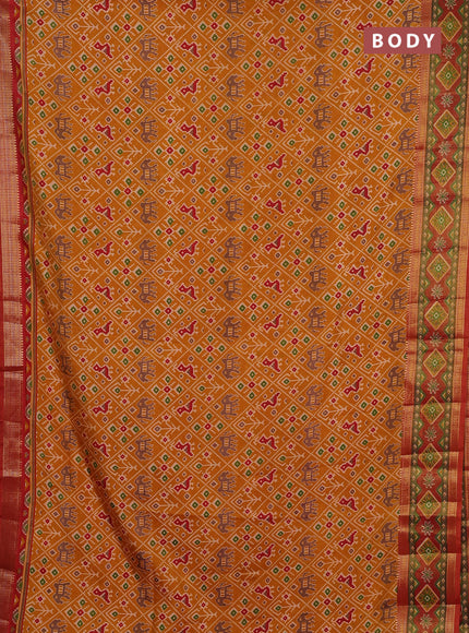 Semi tussar saree mustard yellow and rustic orange with allover patola prints and ikat zari woven border