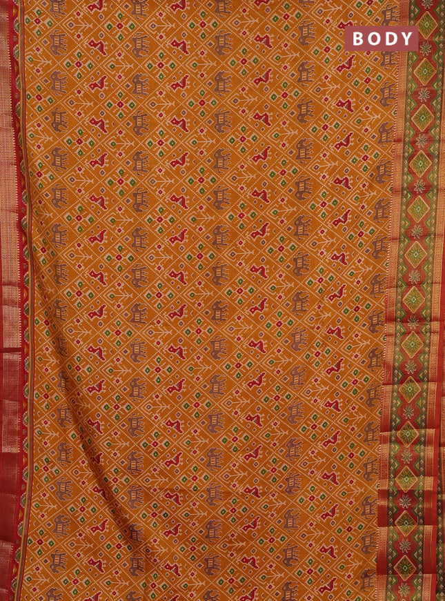 Semi tussar saree mustard yellow and rustic orange with allover patola prints and ikat zari woven border