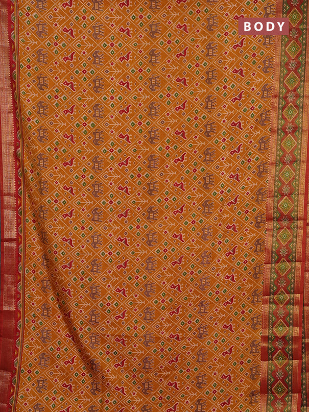 Semi tussar saree mustard yellow and rustic orange with allover patola prints and ikat zari woven border