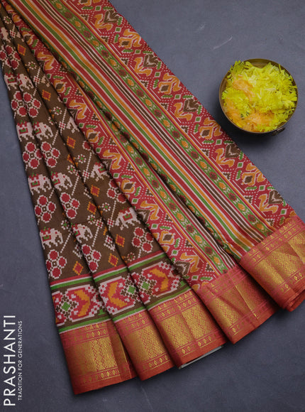 Semi tussar saree mehendi green and rust shade with allover patola prints and zari woven border