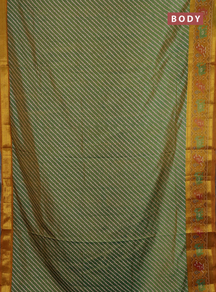 Semi tussar saree light green and mustard yellow with allover leheriya style ikat weaves and ikat woven zari border