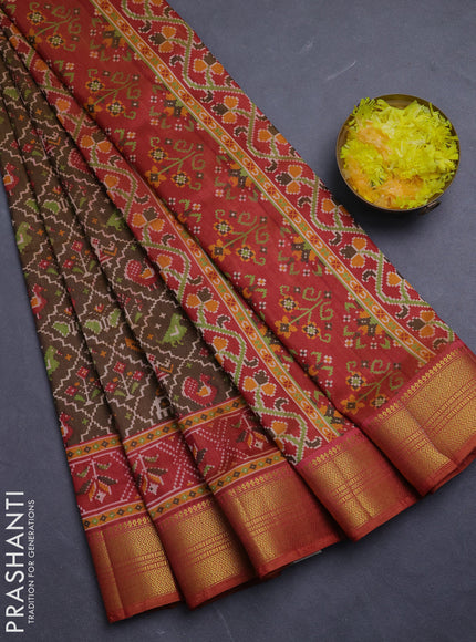 Semi tussar saree mehendi green and rust shade with allover patola prints and zari woven border