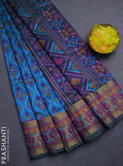 Semi tussar saree dual shade of bluish green and purple with allover ikat prints and ikat woven zari border