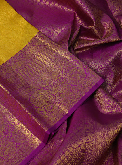 Pure kanchipuram silk saree yellow and purple with allover zari woven brocade weaves and long rich zari woven border