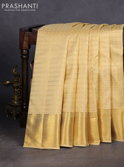 Pure kanchipuram silk saree pale yellow with allover small zari checks & buttas and rich zari woven border