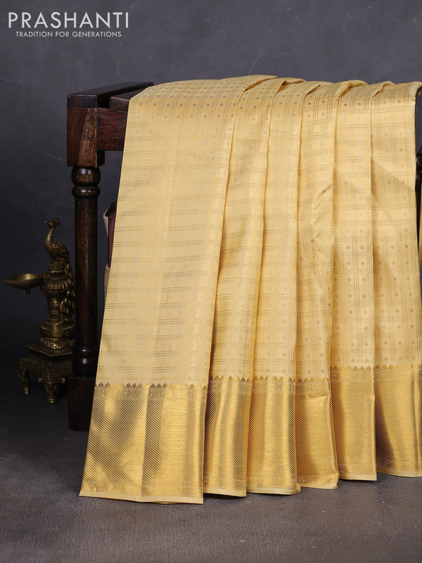 Pure kanchipuram silk saree pale yellow with allover small zari checks & buttas and rich zari woven border