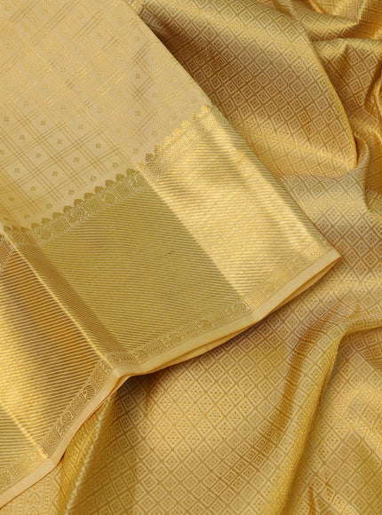 Pure kanchipuram silk saree pale yellow with allover small zari checks & buttas and rich zari woven border