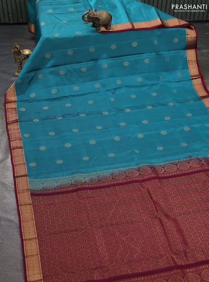 Kanchipuram silk saree peacock green and dark magenta pink with zari woven buttas and zari woven border