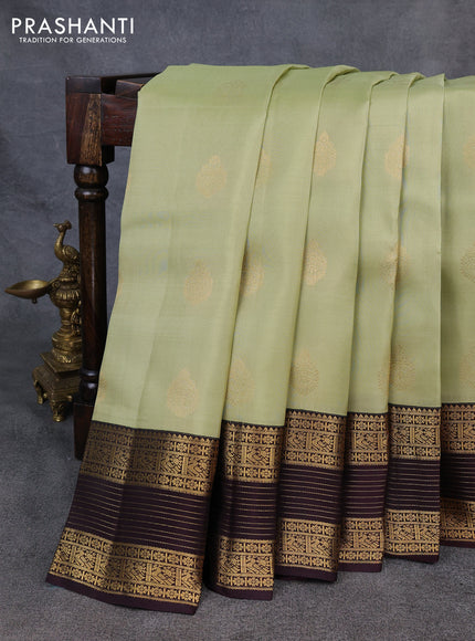 Kanchipuram silk saree pista green and coffee brown with allover zari woven buttas and long zari woven border