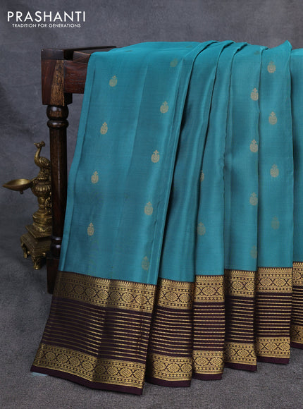 Kanchipuram silk saree peacock green shade and coffee brown with allover zari woven buttas and zari woven korvai border
