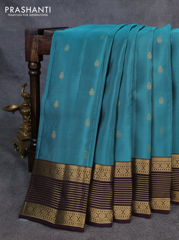 Kanchipuram silk saree peacock green shade and coffee brown with allover zari woven buttas and zari woven korvai border
