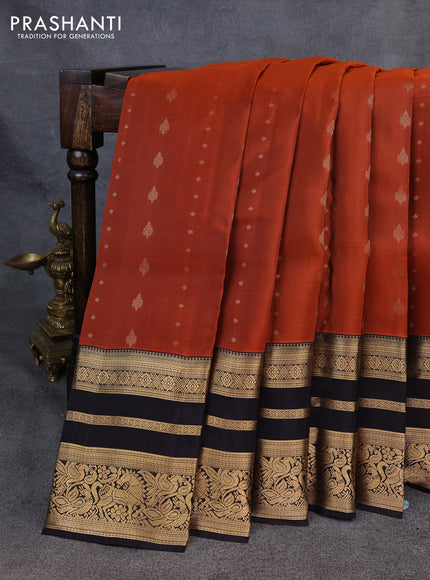 Kanchipuram silk saree rustic orange and black with allover zari woven buttas and long zari woven border