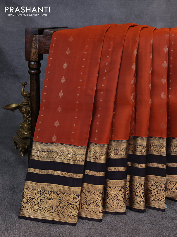 Kanchipuram silk saree rustic orange and black with allover zari woven buttas and long zari woven border