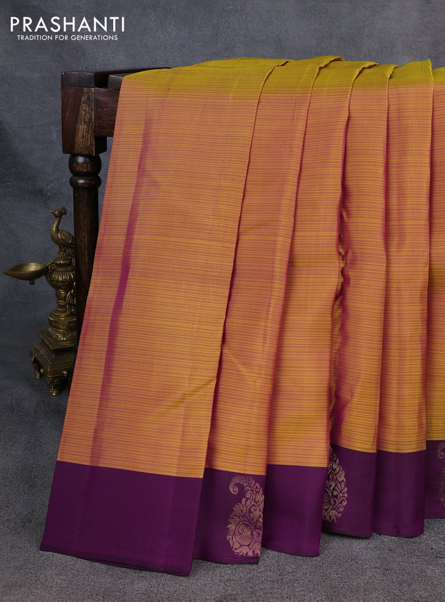 Kanchipuram silk saree mustard yellow and purple with plain body and paisley zari woven butta border