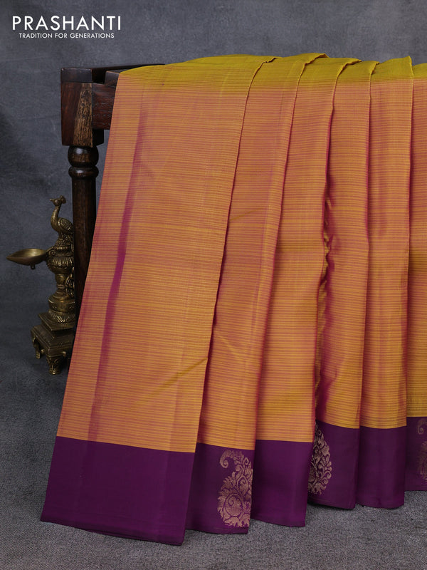 Kanchipuram silk saree mustard yellow and purple with plain body and paisley zari woven butta border