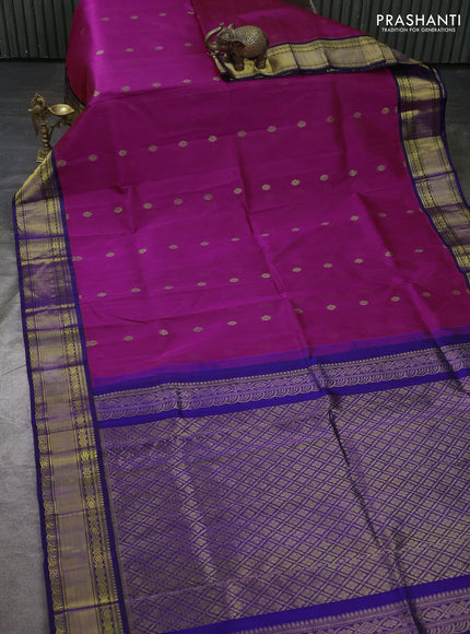 Kuppadam silk cotton saree dual shade of bluish pink and navy blue with allover zari woven buttas and zari woven korvai border
