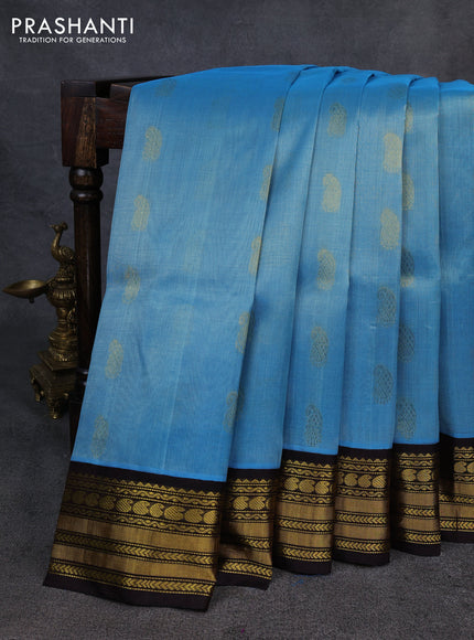 Kuppadam silk cotton saree blue shade and coffee brown with allover paisley zari woven buttas and zari woven korvai border