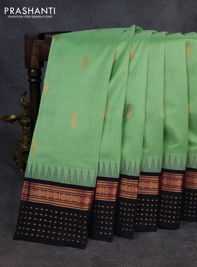 Kuppadam silk cotton saree pista green and black with zari woven buttas and temple design zari woven butta border