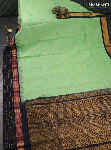 Kuppadam silk cotton saree pista green and black with zari woven buttas and temple design zari woven butta border