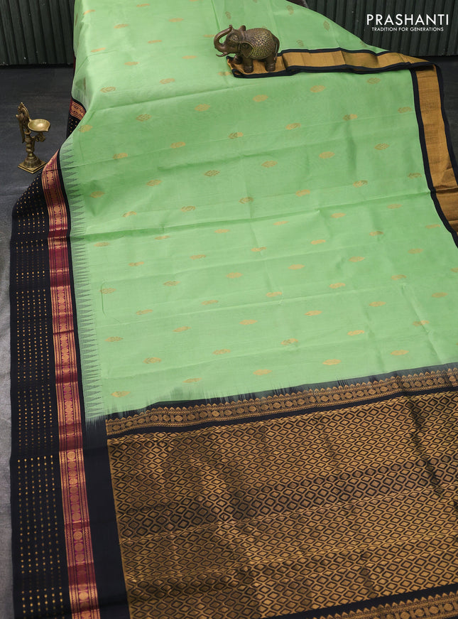 Kuppadam silk cotton saree pista green and black with zari woven buttas and temple design zari woven butta border
