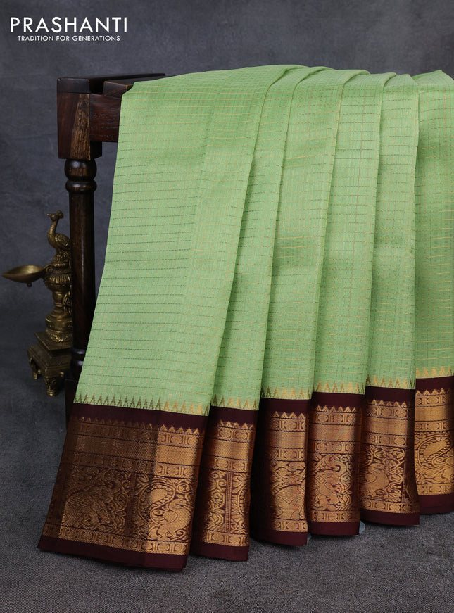 Kuppadam silk cotton saree pista green and coffee brown with allover laksha deepam pattern and temple design zari woven border