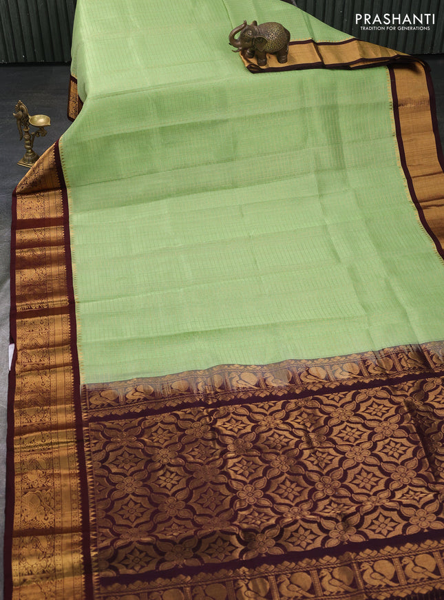 Kuppadam silk cotton saree pista green and coffee brown with allover laksha deepam pattern and temple design zari woven border