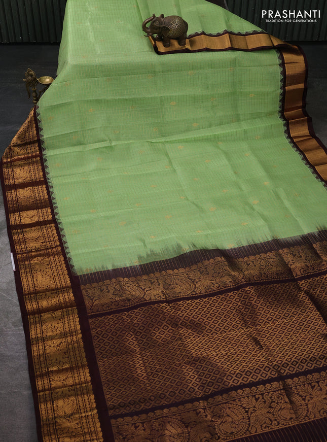 Kuppadam silk cotton saree pista green and coffee brown with allover zari checked pattern and temple design zari woven border