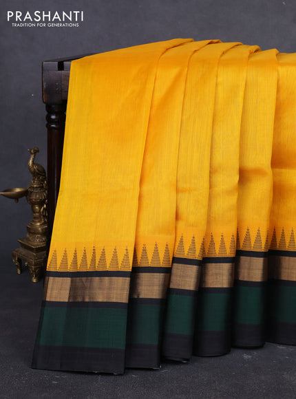 Kuppadam silk cotton saree yellow and bottle green black with plain body and temple design zari woven simple border