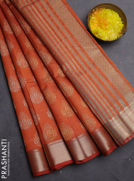Semi raw silk saree rust shade with allover butta prints and zari woven border