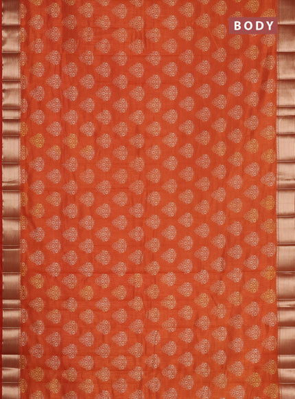 Semi raw silk saree rust shade with allover butta prints and zari woven border
