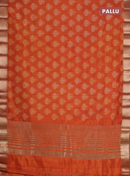 Semi raw silk saree rust shade with allover butta prints and zari woven border