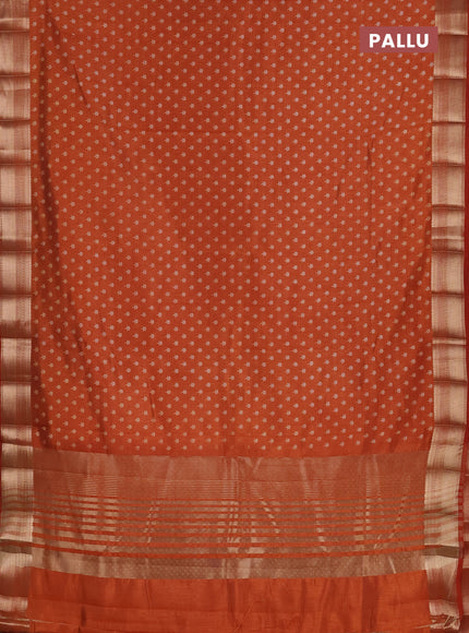 Semi raw silk saree rust shade with allover butta prints and zari woven border