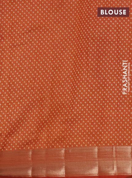 Semi raw silk saree rust shade with allover butta prints and zari woven border