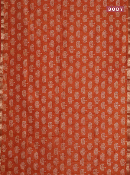 Semi raw silk saree rust shade with allover butta prints and zari woven border
