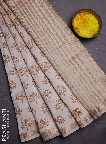 Semi raw silk saree cream with allover butta prints and zari woven border