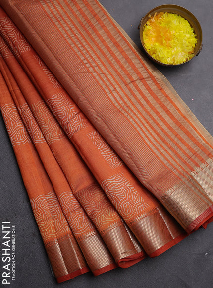Semi raw silk saree rust shade with allover box type butta prints and zari woven border