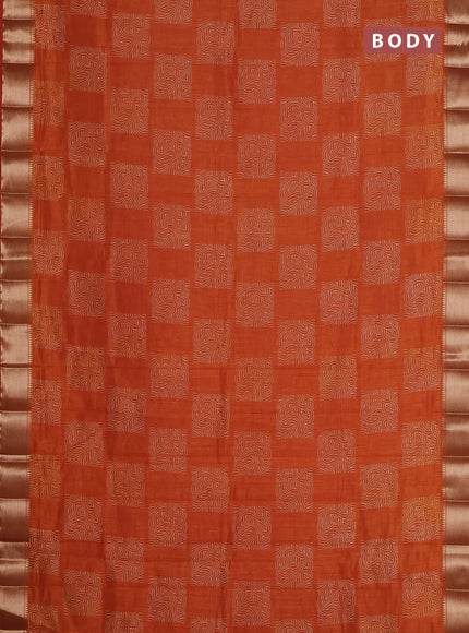 Semi raw silk saree rust shade with allover box type butta prints and zari woven border